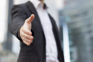 Businessman with an open hand ready to seal a deal